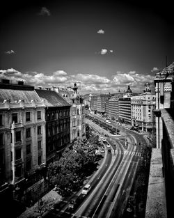 High angle view of railroad tracks by city against sky