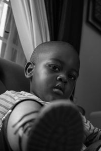 Portrait of boy sitting at home