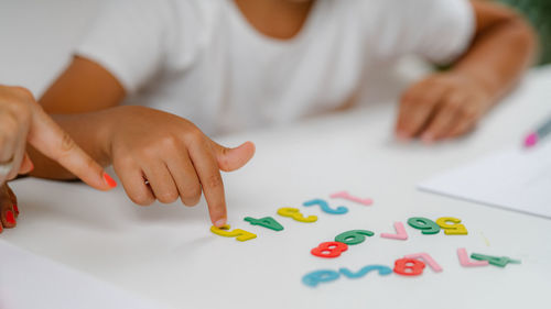 Preschooler screening test. boy pointing on numbers and answering questions.