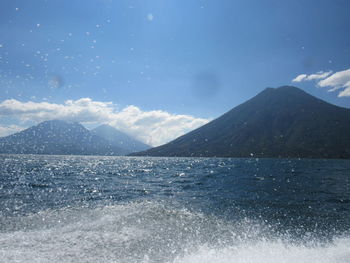 Scenic view of sea and mountains against sky