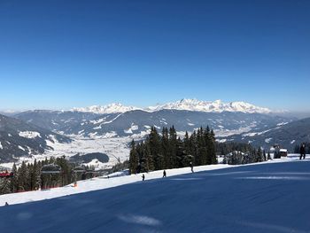 Scenic view of snowcapped mountains against clear blue sky