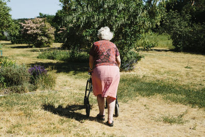 Senior woman walking with walking frame