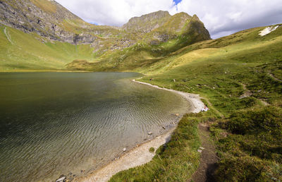 Scenic view of sea and mountains against sky