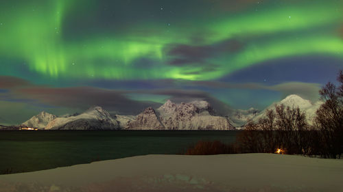 Scenic view of snowcapped mountains against sky at night