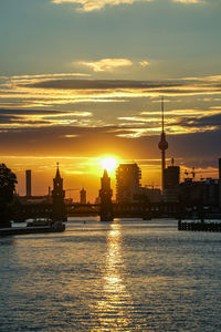 Buildings in city during sunset