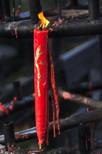 Close-up of lit red candle