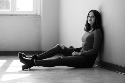 Woman sitting on floor at home