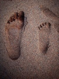 High angle view of footprints on sand