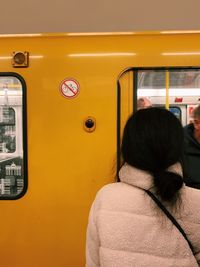 Rear view of woman on train window