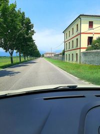 Empty road against sky seen through car windshield