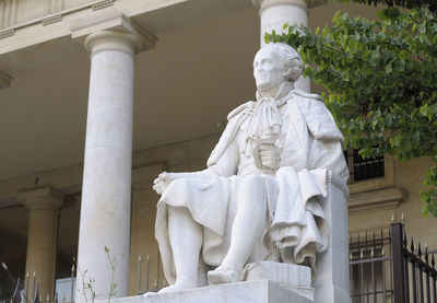 Low angle view of statue against historic building