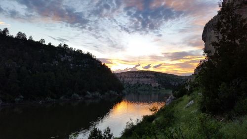 Scenic view of lake against cloudy sky