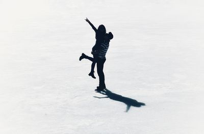 Full length of silhouette man on snow field