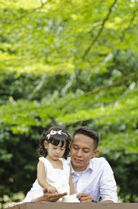 Father teaching savings to daughter at park