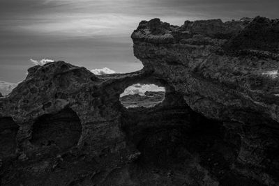 Rock formation on land against sky