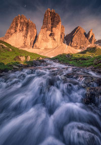 Scenic view of waterfall against sky