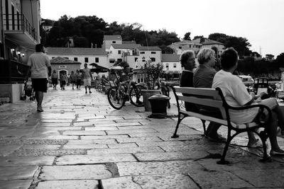 Rear view of people sitting on chair