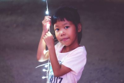 Portrait of smiling girl holding camera