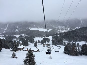 Ski lift over snow covered landscape