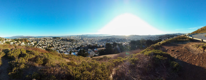 Panoramic view of landscape against blue sky