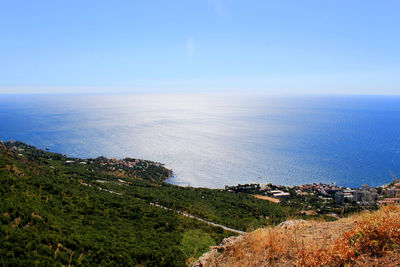 High angle view of sea against clear blue sky