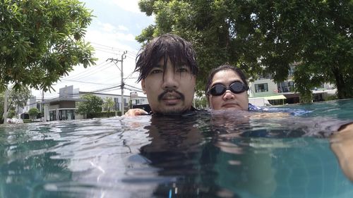 Portrait of young man swimming in pool