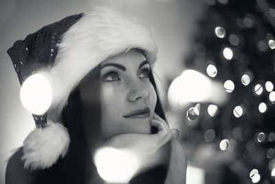 Close-up of thoughtful woman wearing santa hat