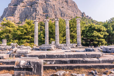 Stone structure against trees