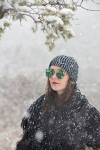 Portrait of young woman in park during winter