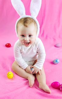 Portrait of cute baby boy lying on bed