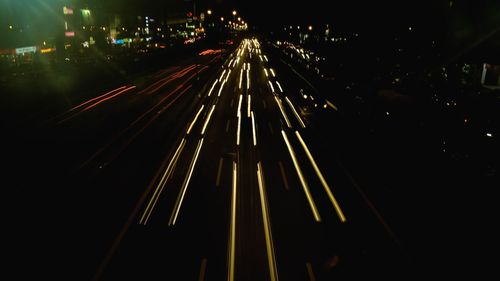 High angle view of light trails on road in city at night