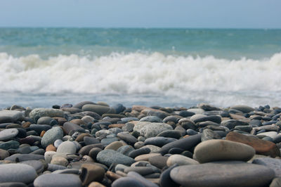 Rocks on beach against sky