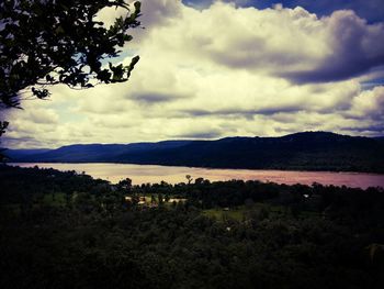 Scenic view of lake against cloudy sky