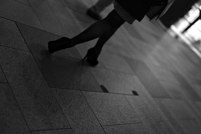 Low section of woman on tiled floor