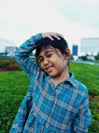 Portrait of happy boy standing on field