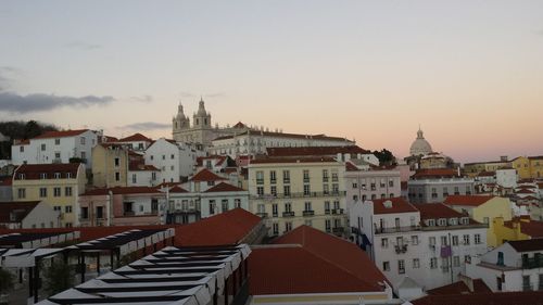 Buildings in town against sky