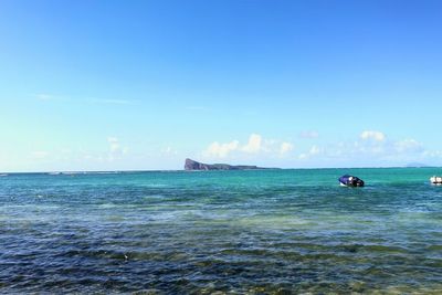 Scenic view of sea against blue sky