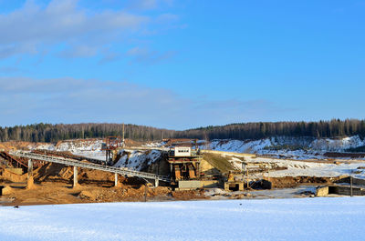 Scenic view of field against blue sky during winter