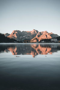 Scenic view of lake and mountains against clear sky