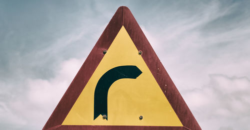 Low angle view of road sign against sky