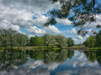 Scenic view of lake by trees against sky