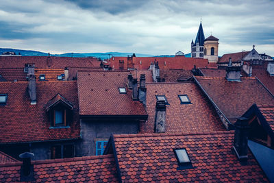 Red roof against sky in city