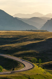 High angle view of road by mountains against sky