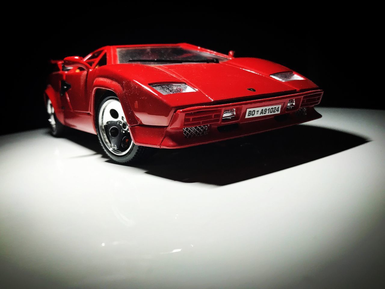 red, toy, toy car, studio shot, no people, black background, close-up, indoors, day