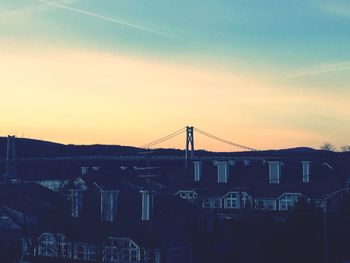 Low angle view of bridge against sky at sunset