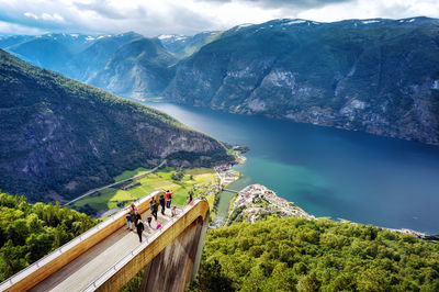 People on mountain against mountains