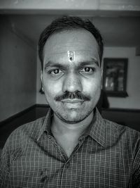 Portrait of man with mustache at home