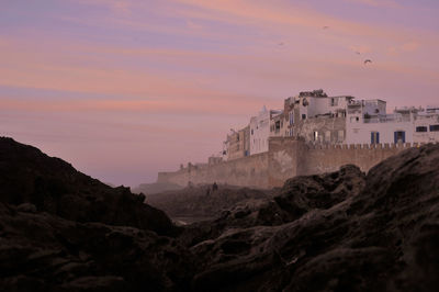 Buildings against sky during sunset