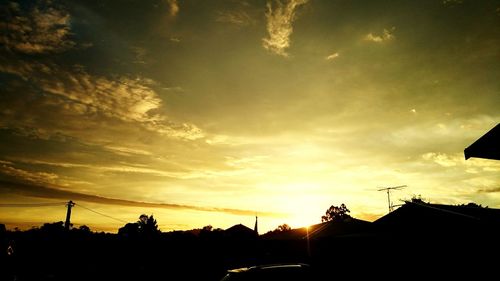 Silhouette trees against sky during sunset