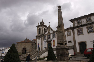 Low angle view of church against cloudy sky